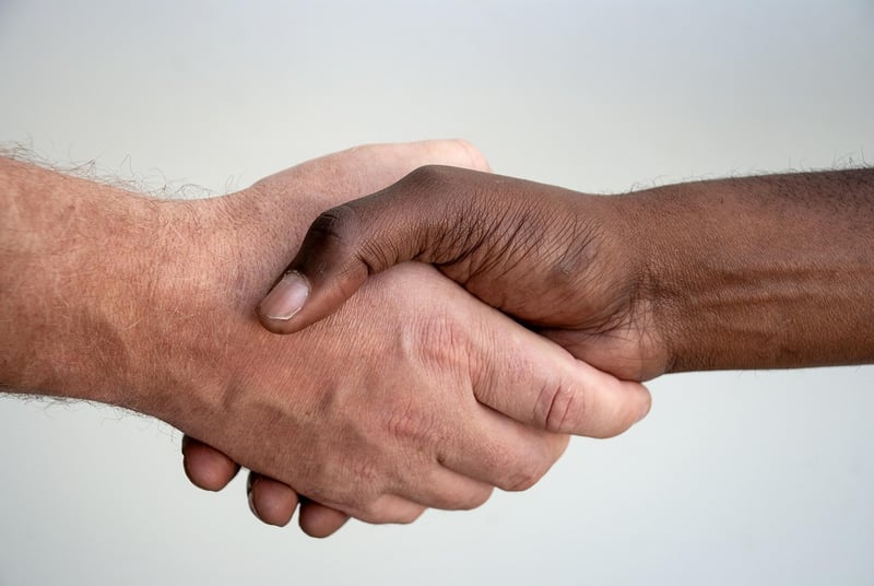 Diverse hands holding a globe